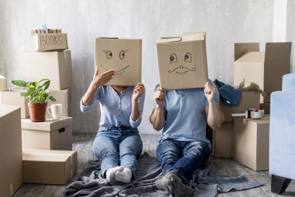 silly-couple-home-moving-day-with-boxes-head